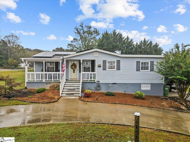 view of front of home featuring covered porch and a front yard