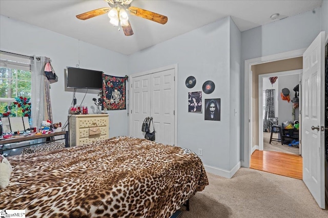 carpeted bedroom featuring a closet and ceiling fan