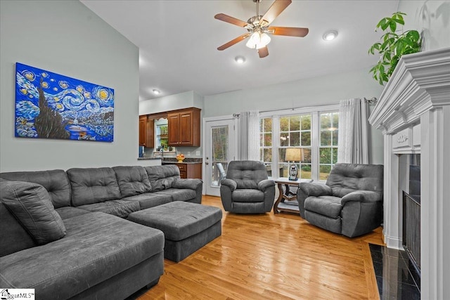 living room with light hardwood / wood-style floors and ceiling fan