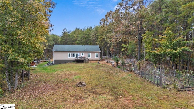 exterior space featuring a wooden deck and an outdoor fire pit