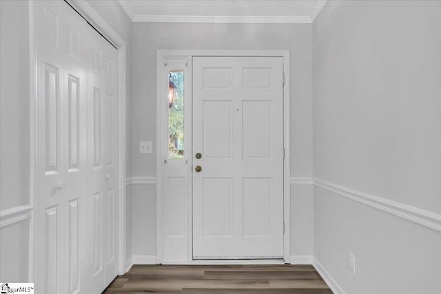 entryway featuring dark wood-type flooring and ornamental molding