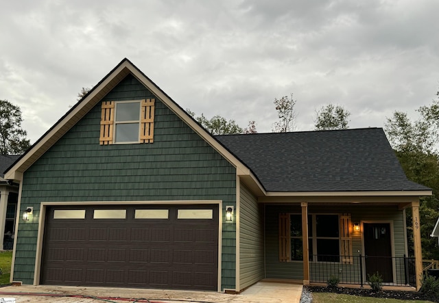 view of front facade with a garage and covered porch