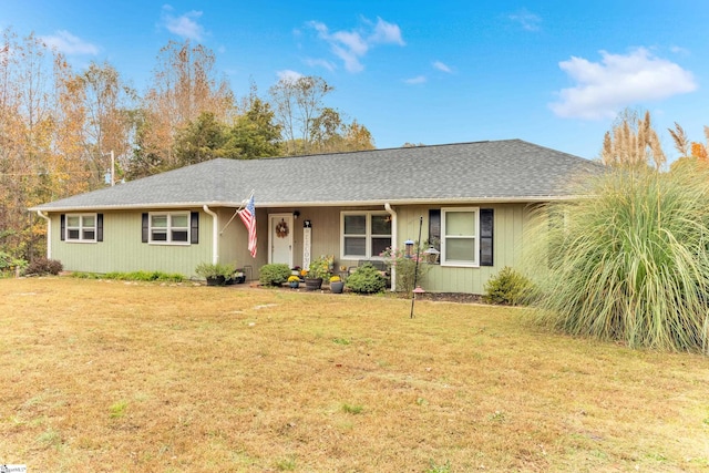 single story home featuring a front lawn