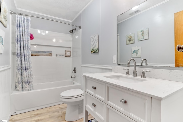 full bathroom featuring wood-type flooring, shower / bath combo with shower curtain, toilet, ornamental molding, and vanity