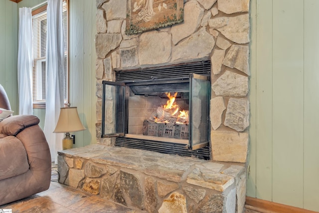 interior details with a stone fireplace