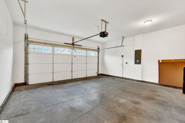 garage featuring electric panel and a garage door opener