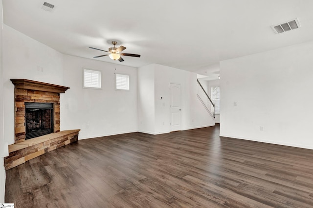 unfurnished living room with dark hardwood / wood-style flooring and ceiling fan