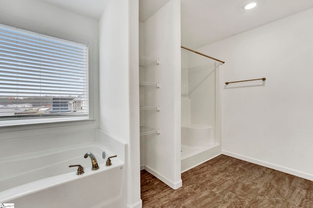 bathroom featuring independent shower and bath and wood-type flooring