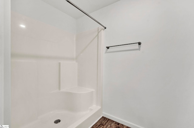 bathroom with walk in shower and wood-type flooring