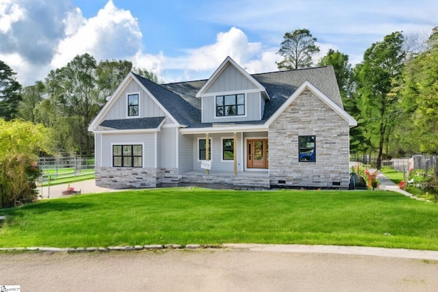 view of front of property with covered porch and a front lawn