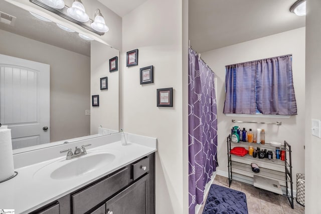 bathroom featuring tile patterned flooring and vanity