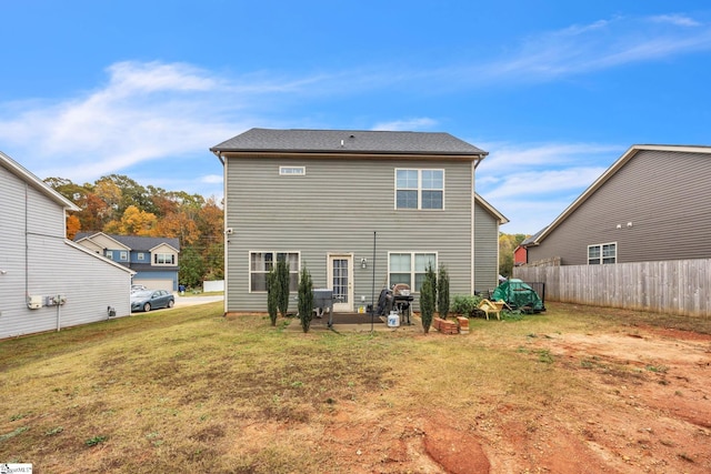 rear view of property with a patio area and a lawn