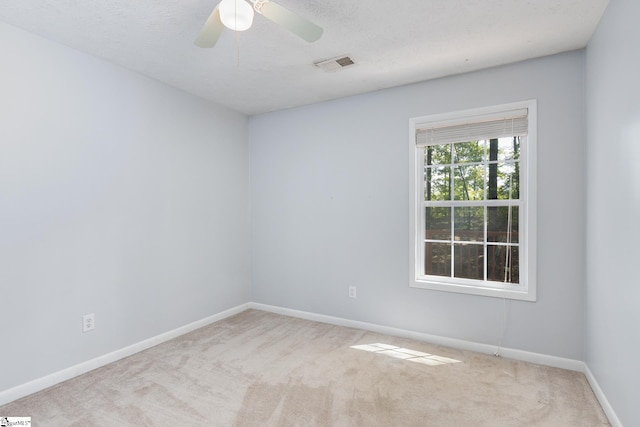 spare room featuring ceiling fan and light colored carpet