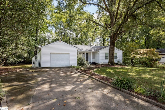 ranch-style house featuring a front lawn and a garage