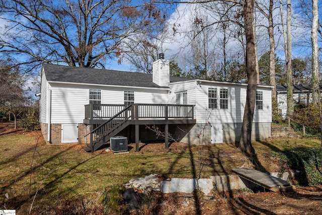 rear view of property with a yard, a deck, and cooling unit