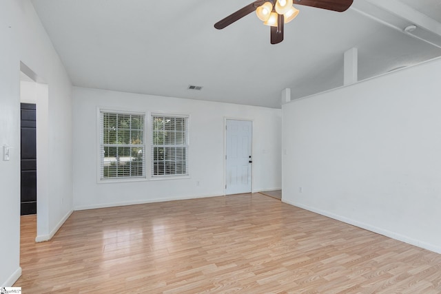 spare room with vaulted ceiling, light hardwood / wood-style flooring, and ceiling fan