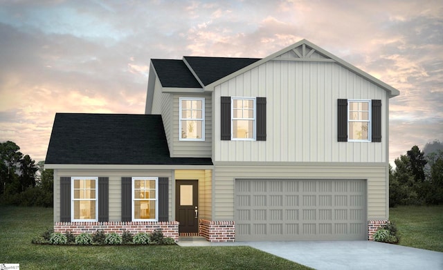 view of front of home with a garage and a yard