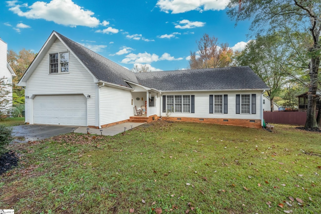 view of front of property with a garage and a front yard