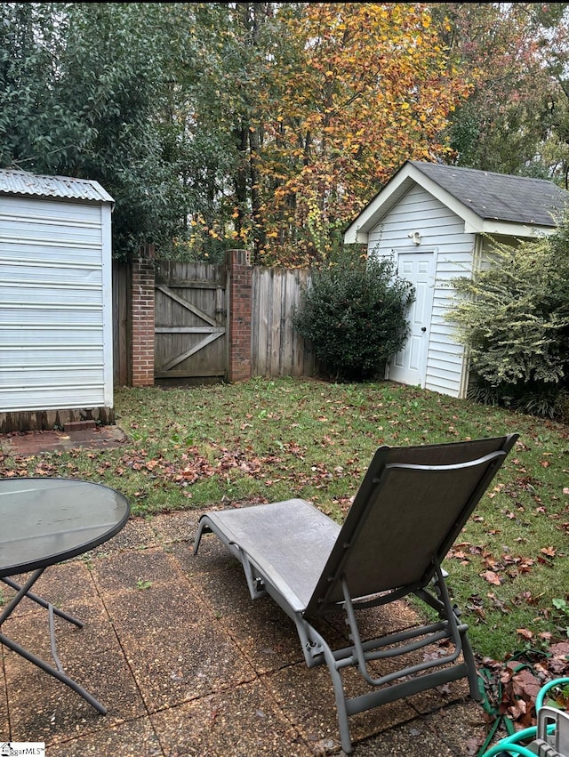 view of yard with a storage shed and a patio area