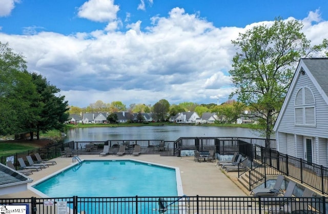 view of swimming pool featuring a water view and a patio