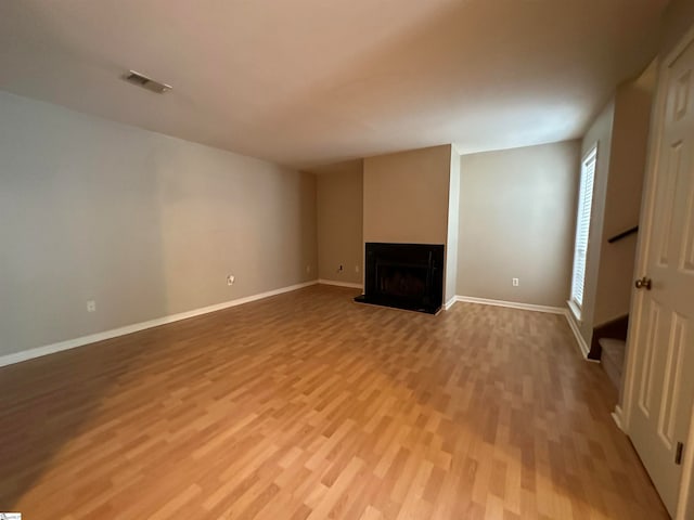 unfurnished living room featuring light hardwood / wood-style floors