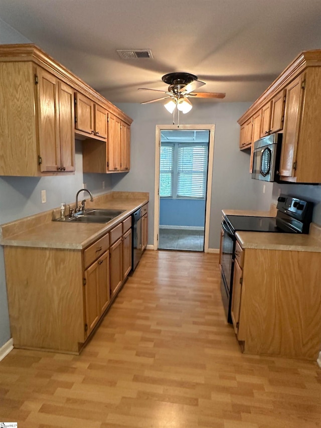 kitchen featuring black appliances, ceiling fan, sink, and light hardwood / wood-style floors