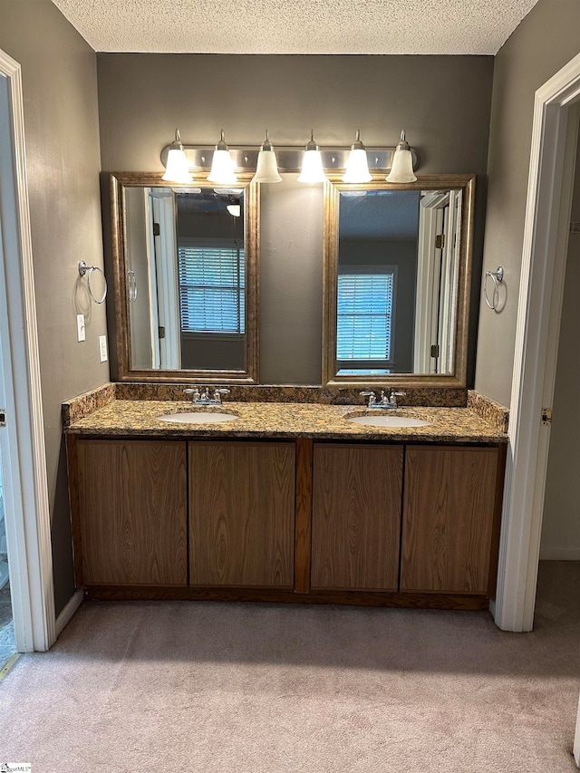 bathroom featuring vanity and a textured ceiling