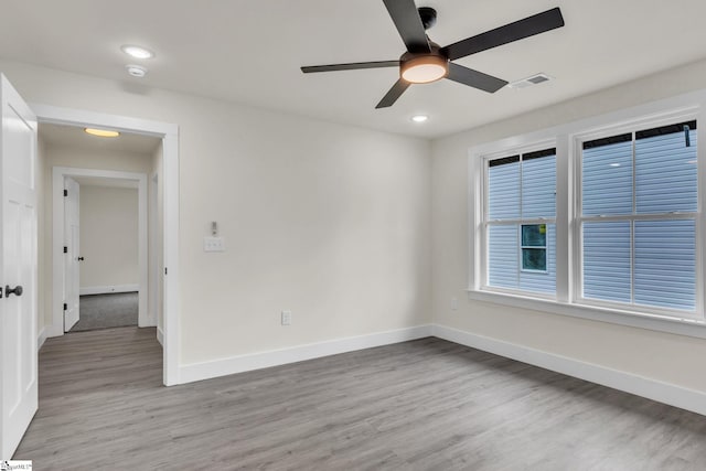 empty room featuring light wood-type flooring and ceiling fan