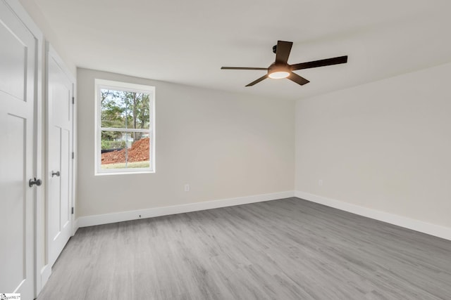 empty room featuring light wood-type flooring and ceiling fan