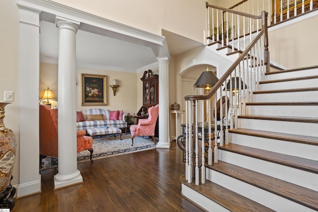 entrance foyer with dark hardwood / wood-style flooring and crown molding