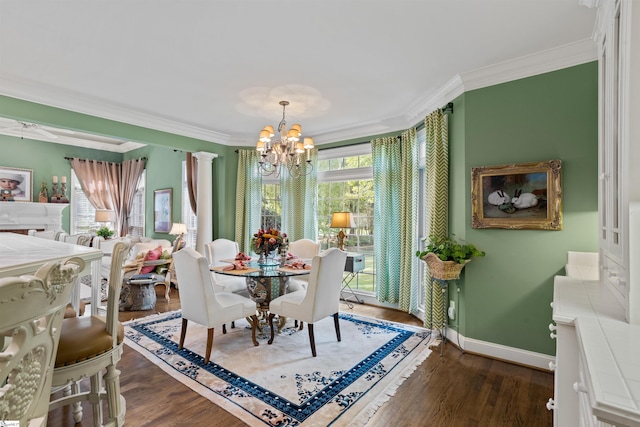 dining room featuring dark wood-type flooring, decorative columns, a chandelier, and ornamental molding