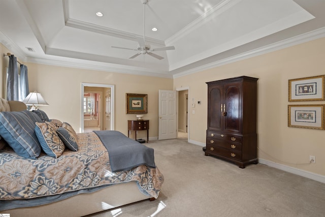 bedroom with ensuite bath, a raised ceiling, ceiling fan, and crown molding