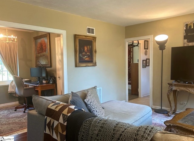 bedroom featuring an inviting chandelier and light wood-type flooring