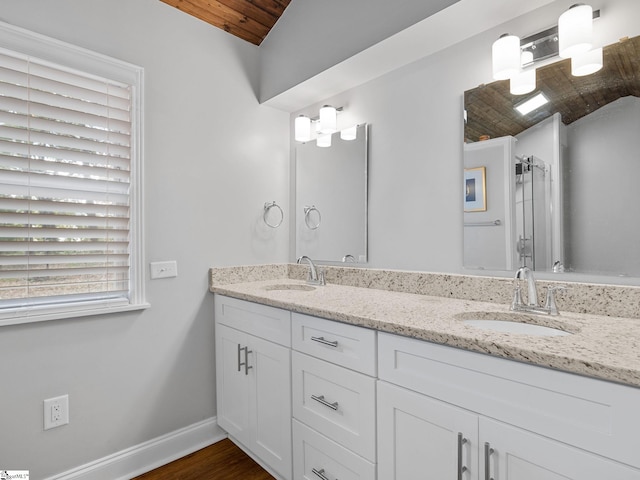 bathroom featuring hardwood / wood-style floors, vanity, and wooden ceiling