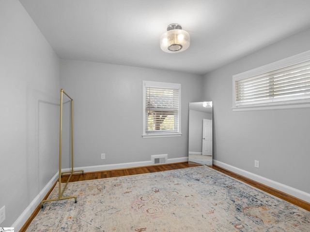 unfurnished room featuring wood-type flooring