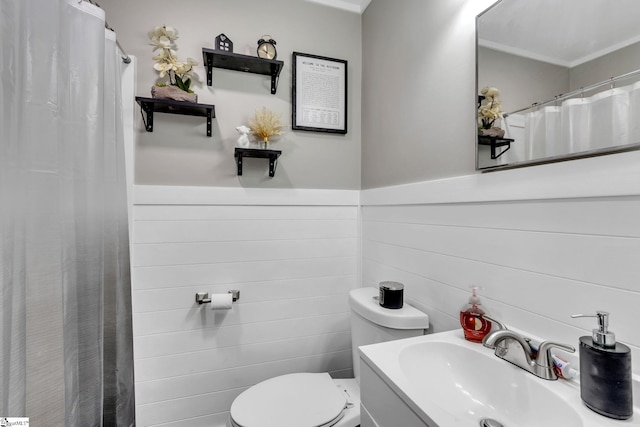 bathroom featuring vanity, toilet, and tile walls