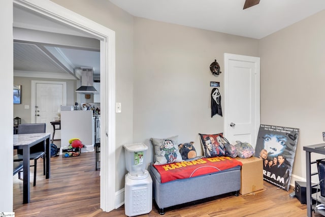 sitting room featuring wood-type flooring and ceiling fan