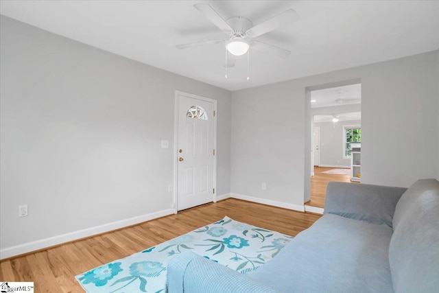 living room with wood-type flooring and ceiling fan