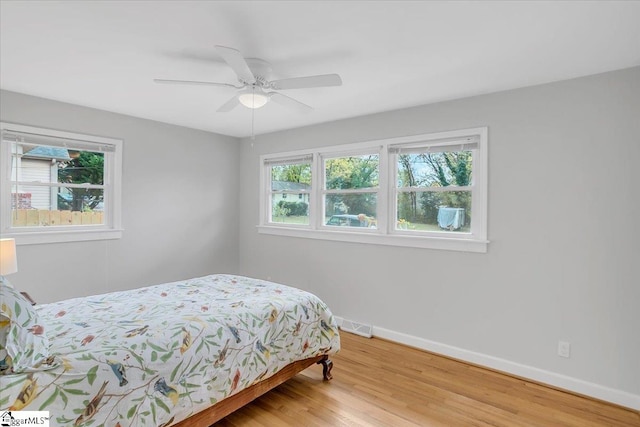 bedroom with wood-type flooring and ceiling fan