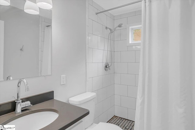 bathroom with curtained shower, vanity, and toilet