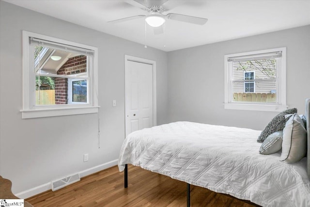 bedroom featuring hardwood / wood-style floors, ceiling fan, and a closet