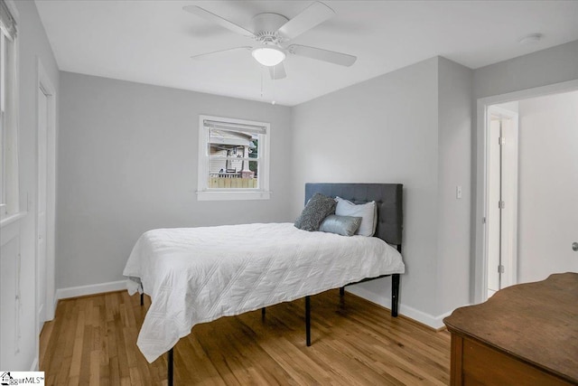 bedroom with light wood-type flooring and ceiling fan