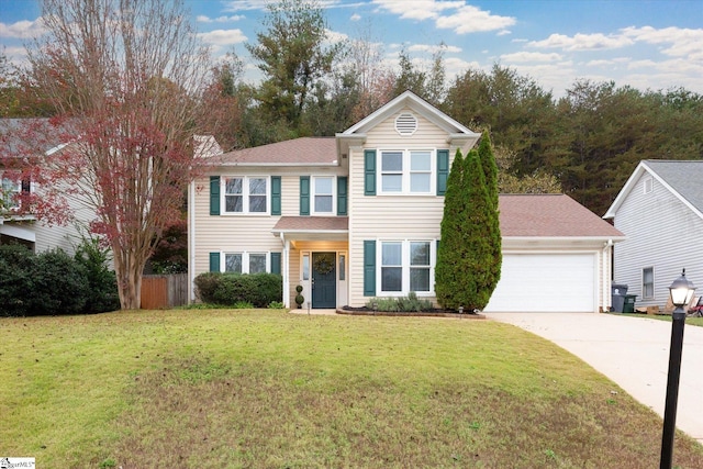 view of front of home with a front yard and a garage