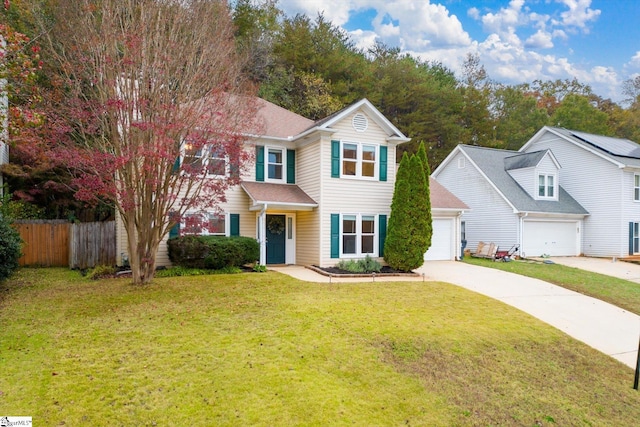 view of front of property featuring a front yard and a garage