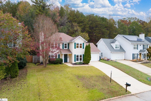 colonial-style house with a garage and a front lawn