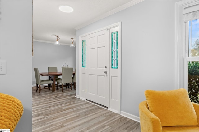 foyer with light wood-type flooring and ornamental molding