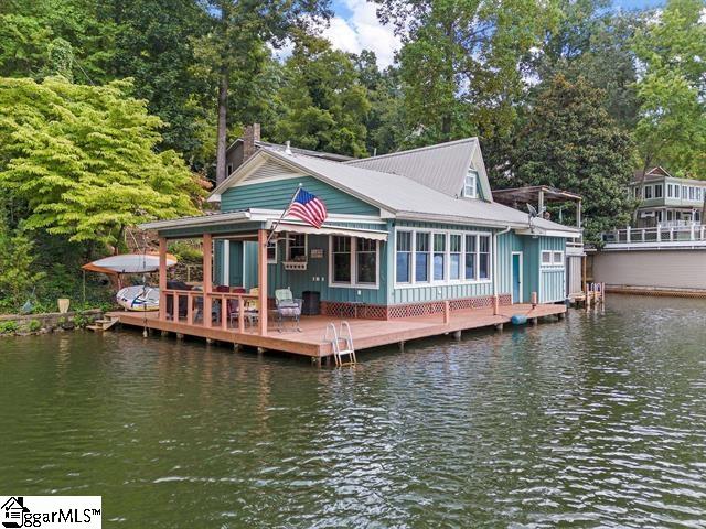 1200 E Lakeshore Dr, Landrum, SC 29356 - rear view of property with a deck with water view, board and batten siding, and a chimney