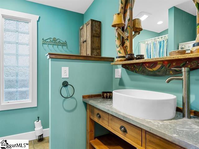 bathroom with tile patterned flooring and vanity