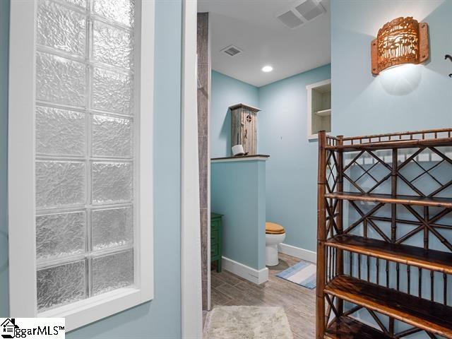 bathroom with wood-type flooring and toilet