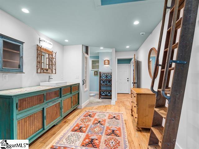 bathroom with hardwood / wood-style floors and vanity